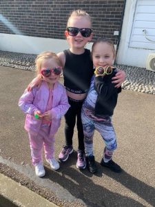 Image shows 3 girls wearing sunglasses