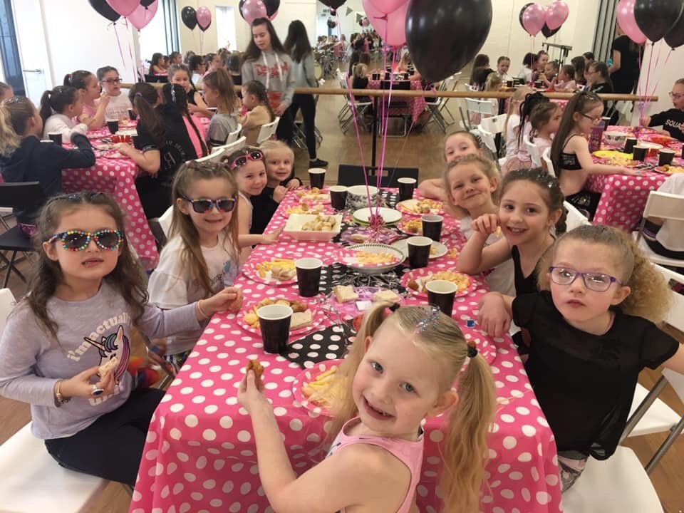 Image shows children sitting at a table