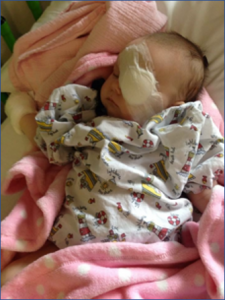 Image shows Emily as a newborn baby