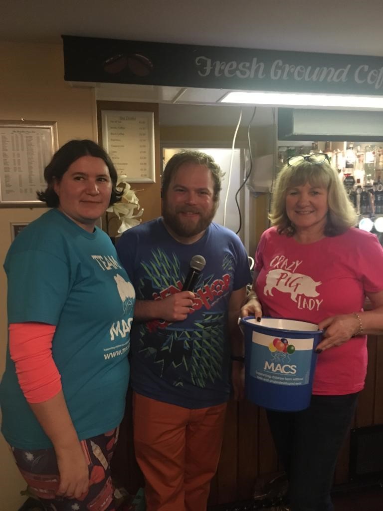 Image shows three people holding a collection bucket