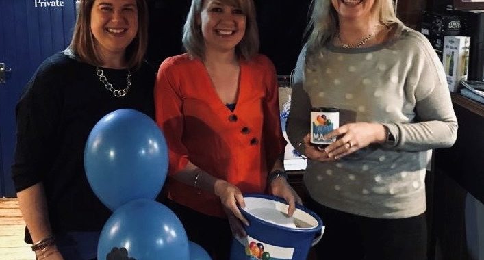 three ladies with a collection bucket