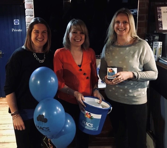 three ladies with a collection bucket